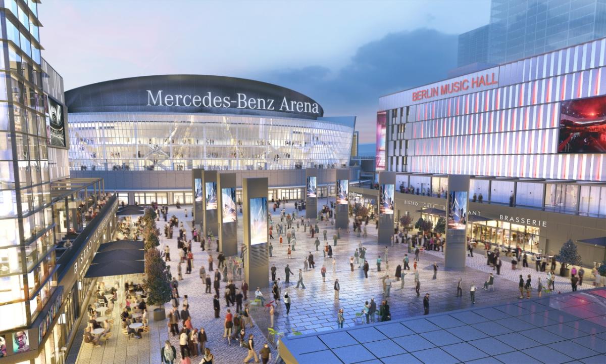 Caption: Artist rendering of Mercedes Platz courtyard with people walking between the buildings in front of the Mercedes-Benz Arena. AEG is developer for the project. AEG is developer for the project.