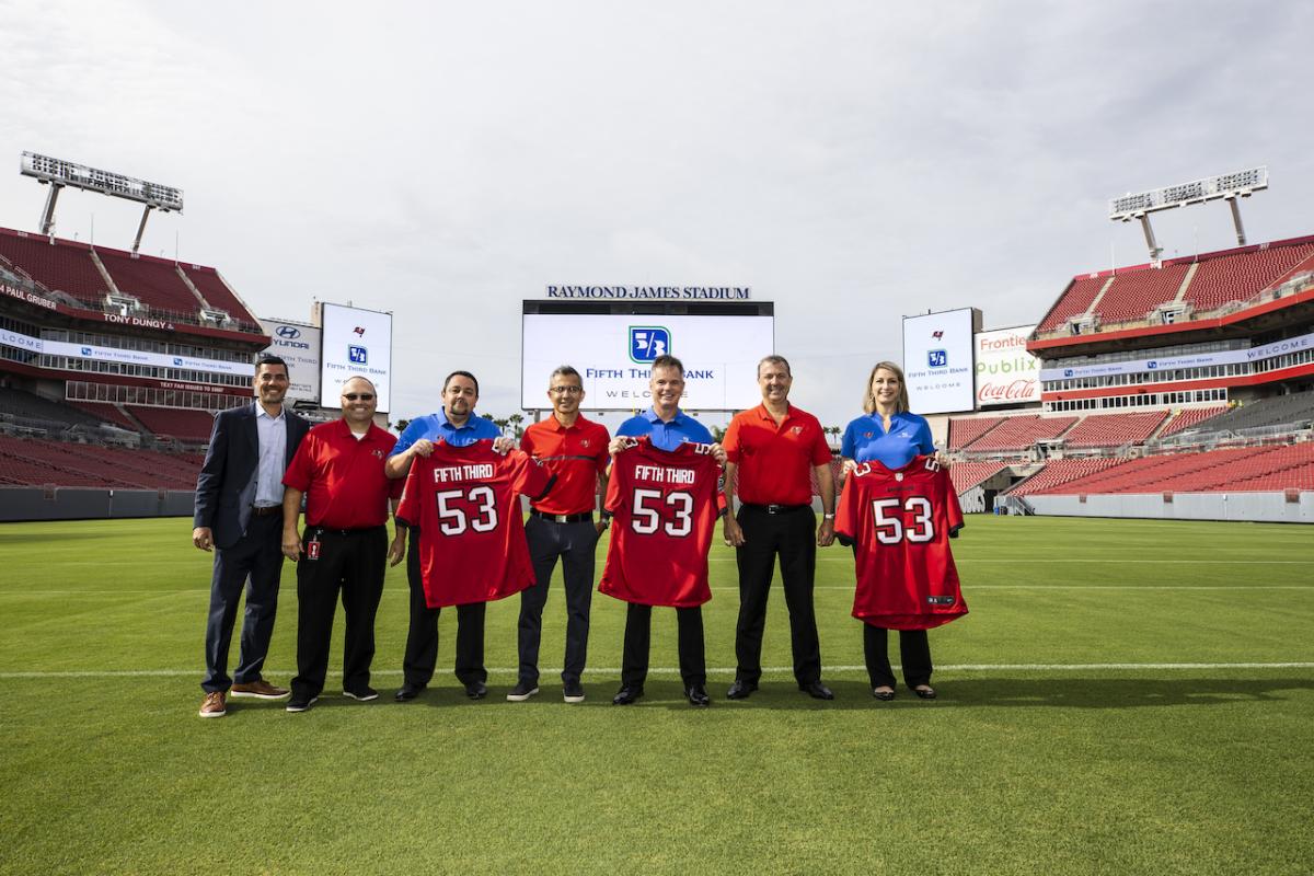 Fifth Third Bank and Tampa Bay Bucs leadership came together on the field to celebrate the new community partnership.