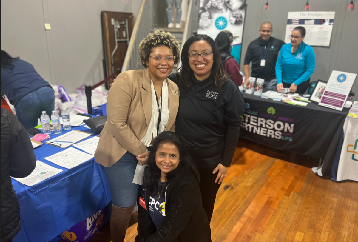 Pictured are:* Ashley Eleby, Service Solutions Representative (left), Umme Choudhury, Community Health Worker, Health Coalition of Passaic County (center) and Bonnie Reyna, Director, Quest for Health Equity (right). 三个人姿势面前的相机表设置为不同的组织。