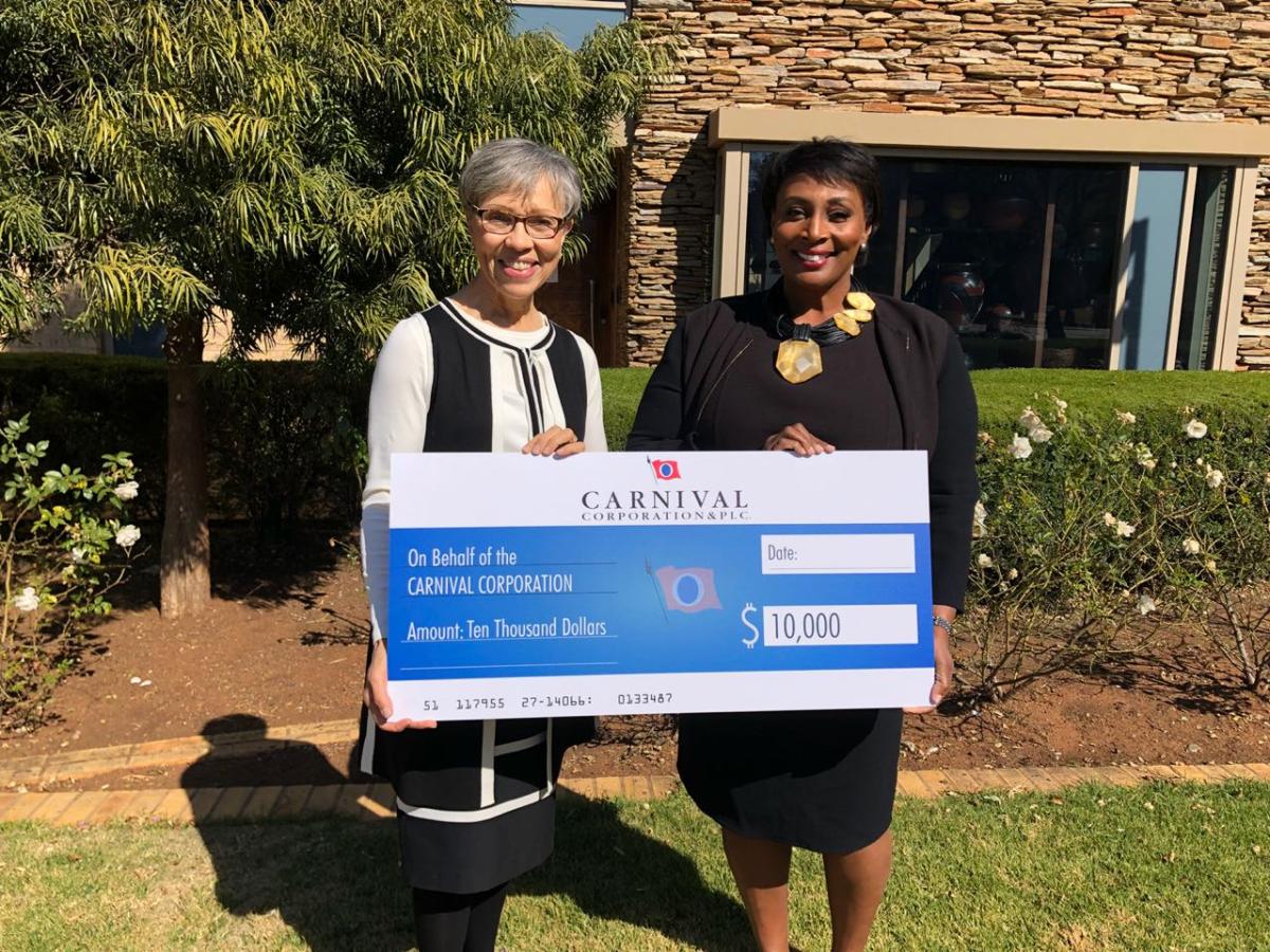 (l to r) Rebecca Sykes, president of the Oprah Winfrey Leadership Academy Foundation, received a $10,000 donation from Julia Brown, chief procurement officer for Carnival Corporation.