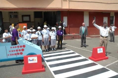 FedEx volunteers (in purple t-shirts) help teach kids in India about road safety