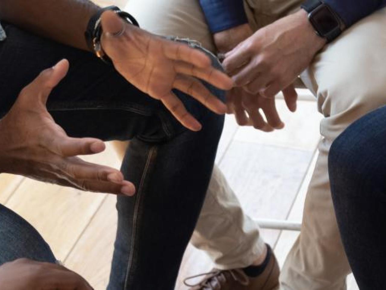 group of hands at a meeting
